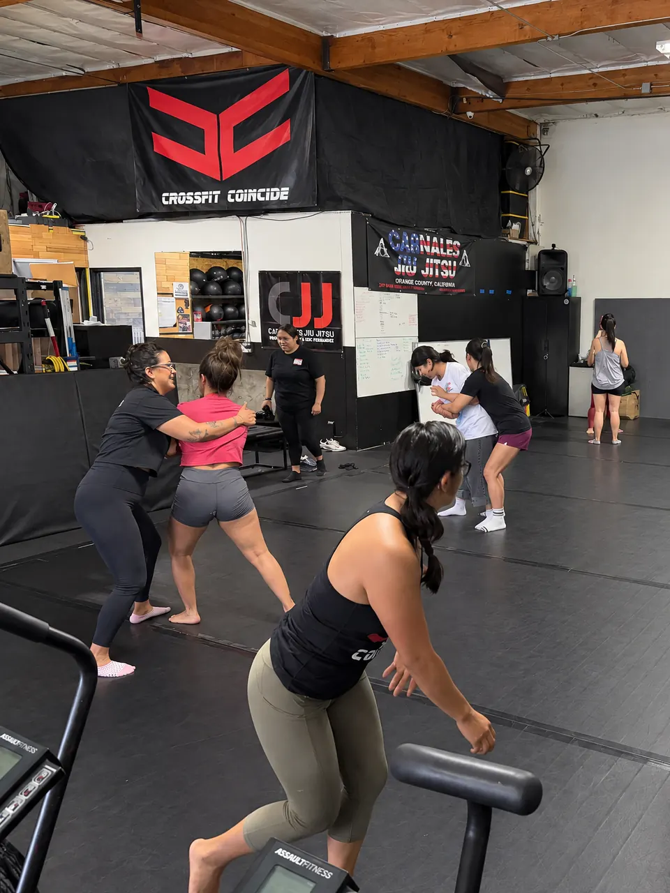 A Carnales Jiu Jitsu class on the mats at CrossFit Coincide, under both gyms’ banners